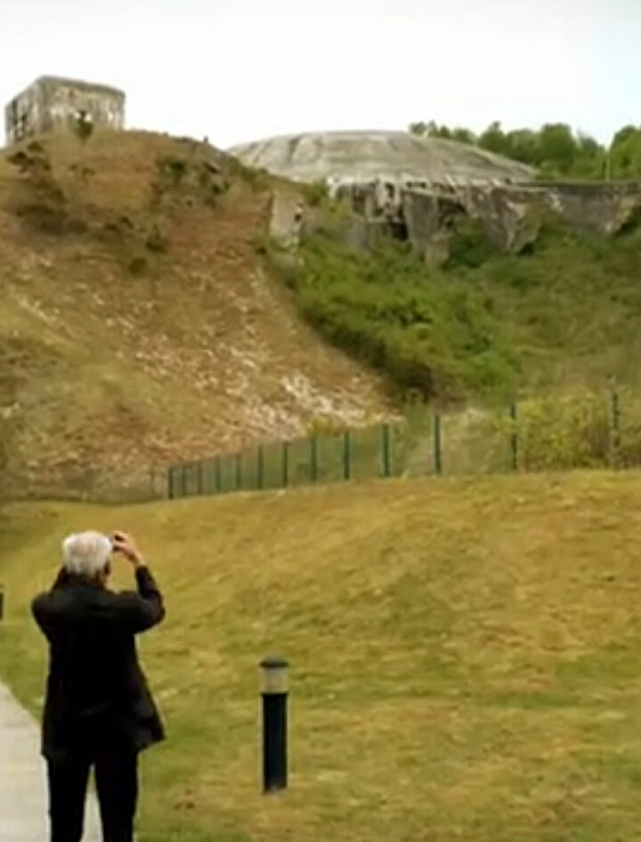 an old man take picture of memorial bunker of st omer form world war two
