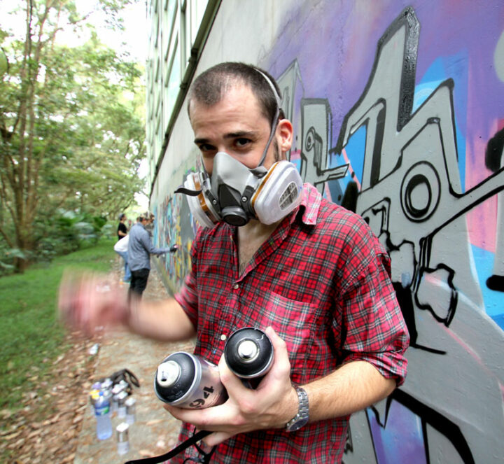 Kanos paint a wall in Hong Kong