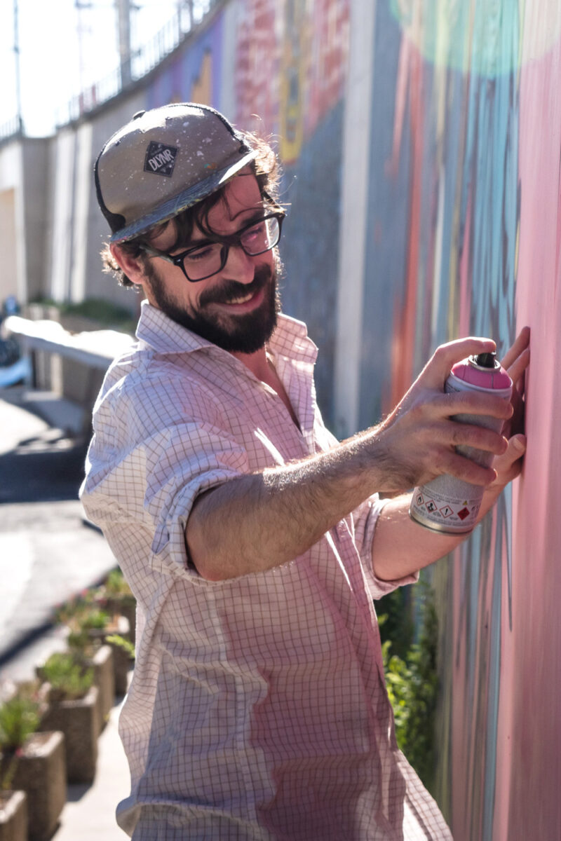 Alex Kanos is painting a mural in Paris
