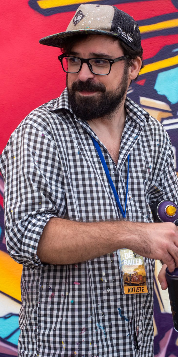 Alex Kanos is holding spray in his hands